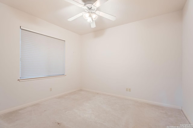 carpeted spare room with baseboards and ceiling fan