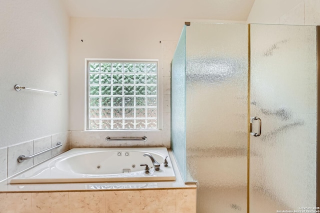 bathroom with a jetted tub and a shower stall