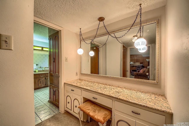 207 Mary Louise Dr, San Antonio, TX 78201 - ensuite bathroom with tile patterned flooring, ensuite bathroom, vanity, and a textured ceiling