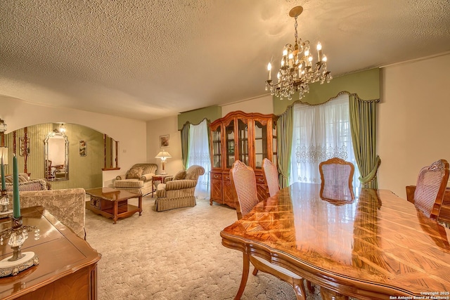 207 Mary Louise Dr, San Antonio, TX 78201 - dining room featuring arched walkways, a textured ceiling, carpet flooring, and an inviting chandelier