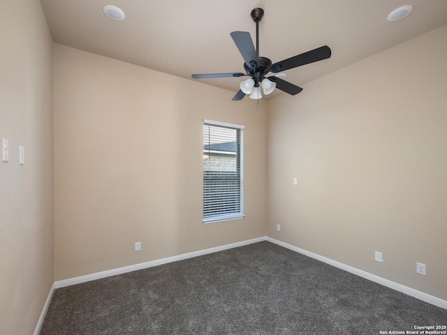 unfurnished room featuring dark carpet, ceiling fan, and baseboards