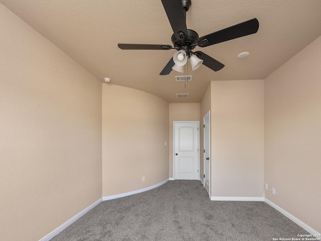 unfurnished room featuring visible vents, carpet flooring, baseboards, and a ceiling fan