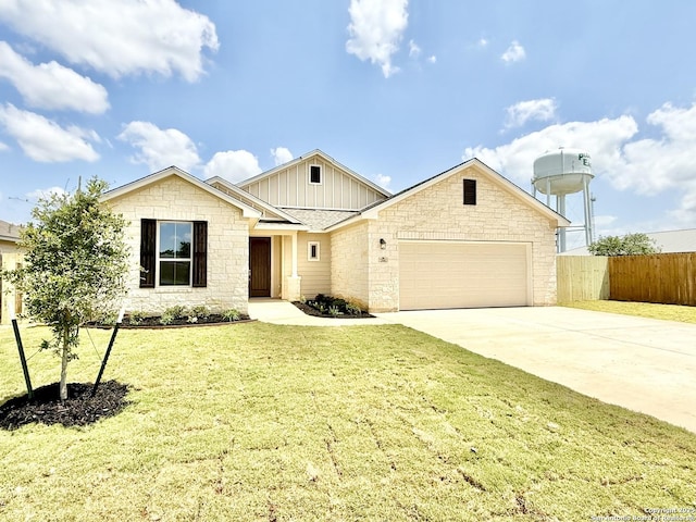 single story home with fence, a front lawn, concrete driveway, an attached garage, and stone siding