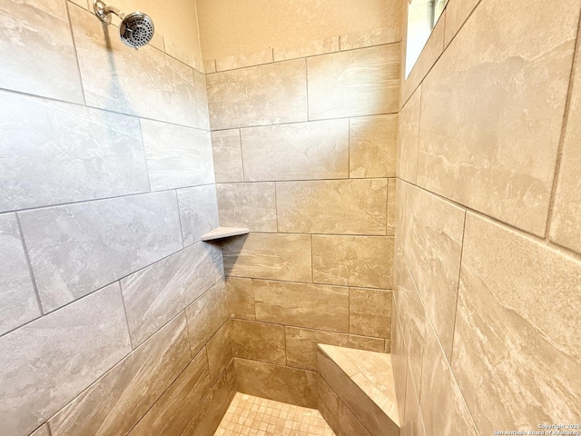 full bath featuring a tile shower