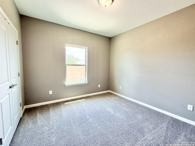 unfurnished bedroom featuring carpet flooring and baseboards