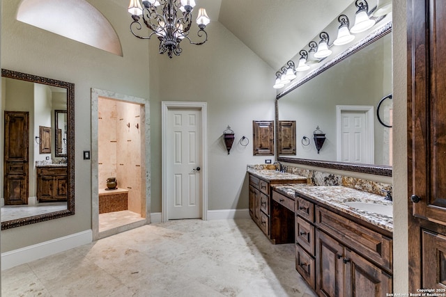 bathroom with a sink, a chandelier, double vanity, and high vaulted ceiling
