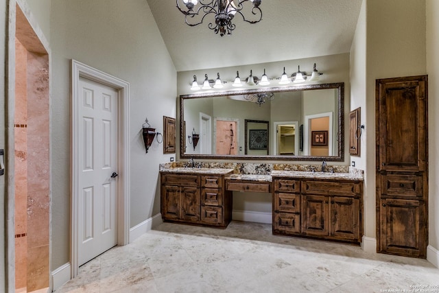 bathroom featuring vaulted ceiling, a chandelier, a sink, and double vanity
