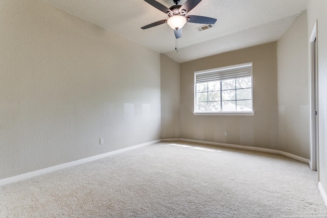 empty room featuring baseboards, visible vents, carpet flooring, and ceiling fan