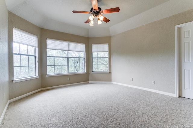 empty room with a ceiling fan, carpet floors, and a healthy amount of sunlight