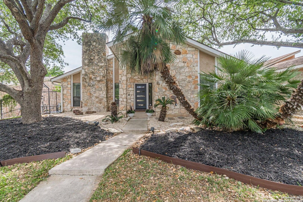 1522 Vista Azul, San Antonio, TX 78213 - view of front of property with stone siding, a chimney, and fence