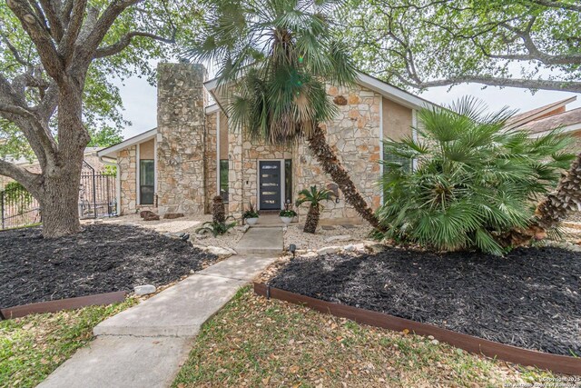 1522 Vista Azul, San Antonio, TX 78213 - view of front of property with stone siding, a chimney, and fence
