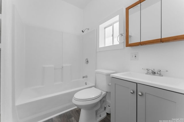 full bathroom with shower / bathing tub combination, wood finished floors, toilet, and vanity
