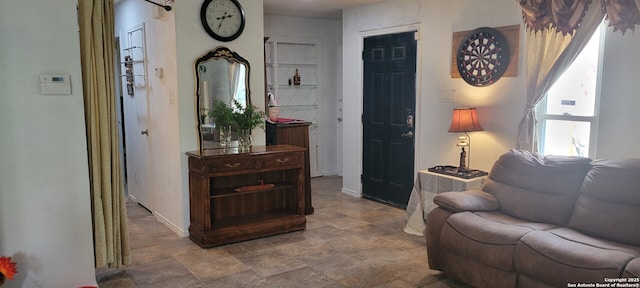 living area with stone finish floor and baseboards
