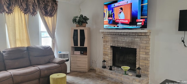 living area featuring stone finish floor and a fireplace