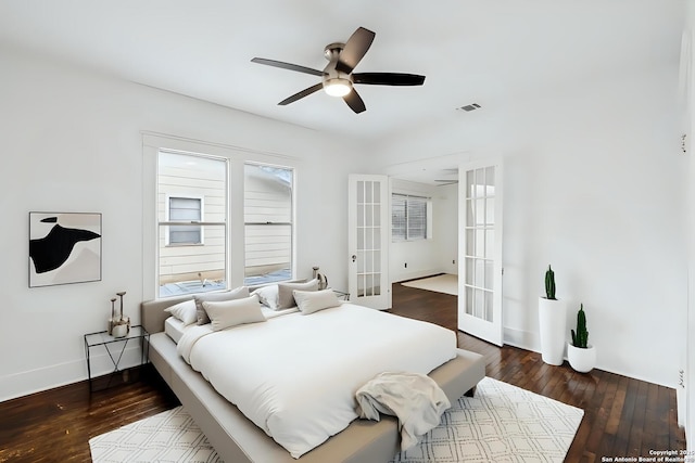 bedroom with dark wood-style floors, visible vents, baseboards, and french doors