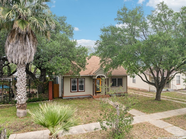 view of front of house featuring a front yard and fence
