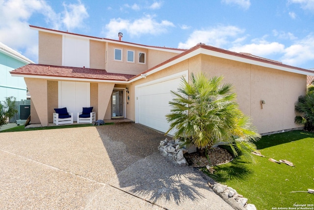 view of front of house with driveway, central AC, a garage, a front yard, and stucco siding