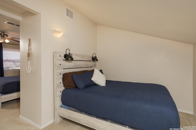 carpeted bedroom featuring baseboards and visible vents