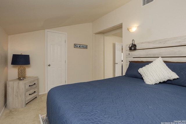 bedroom with light carpet, vaulted ceiling, and visible vents