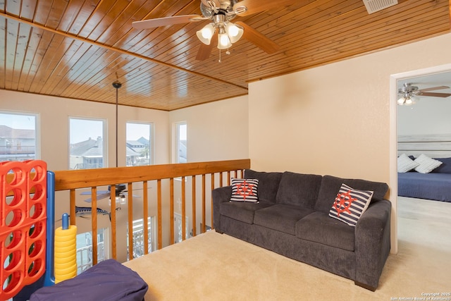 living room with carpet flooring, wood ceiling, and ceiling fan