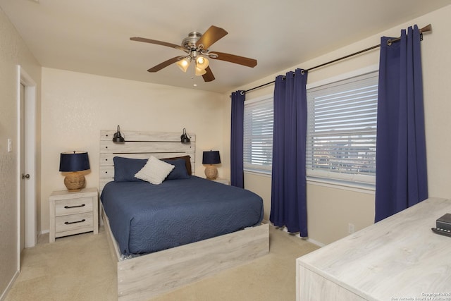 carpeted bedroom with baseboards and a ceiling fan