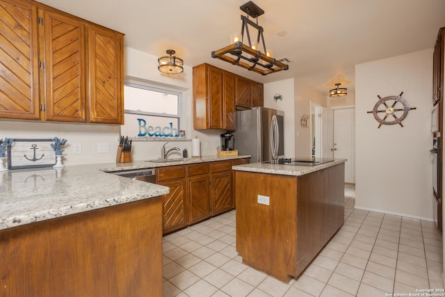 kitchen featuring brown cabinetry, a sink, stainless steel appliances, and light tile patterned floors