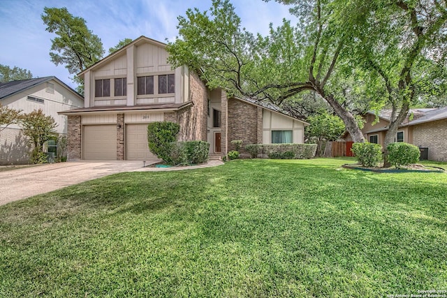 view of front of house with fence, a front lawn, concrete driveway, an attached garage, and brick siding