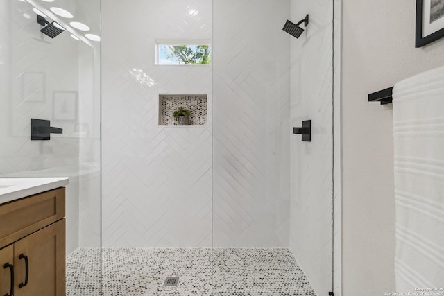 full bath with vanity and tiled shower