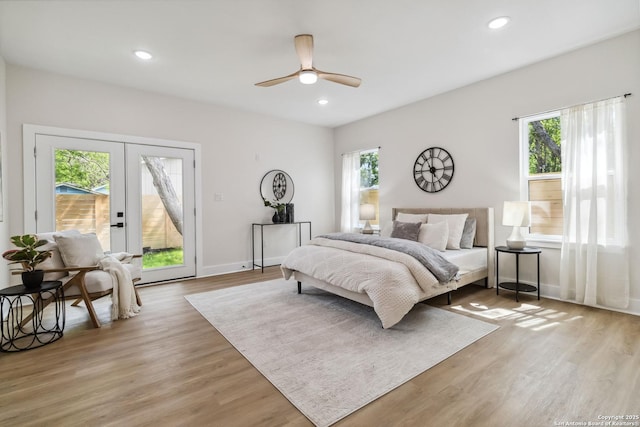 bedroom with recessed lighting, access to outside, and light wood-style flooring