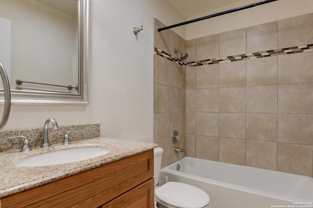 bathroom with shower / bath combination, toilet, and vanity