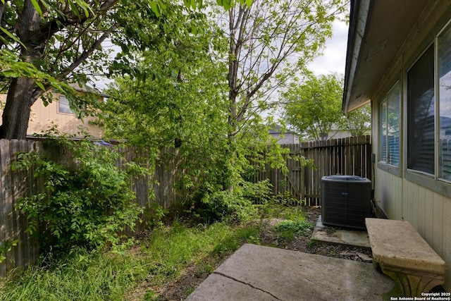 view of yard featuring cooling unit, a patio area, and a fenced backyard