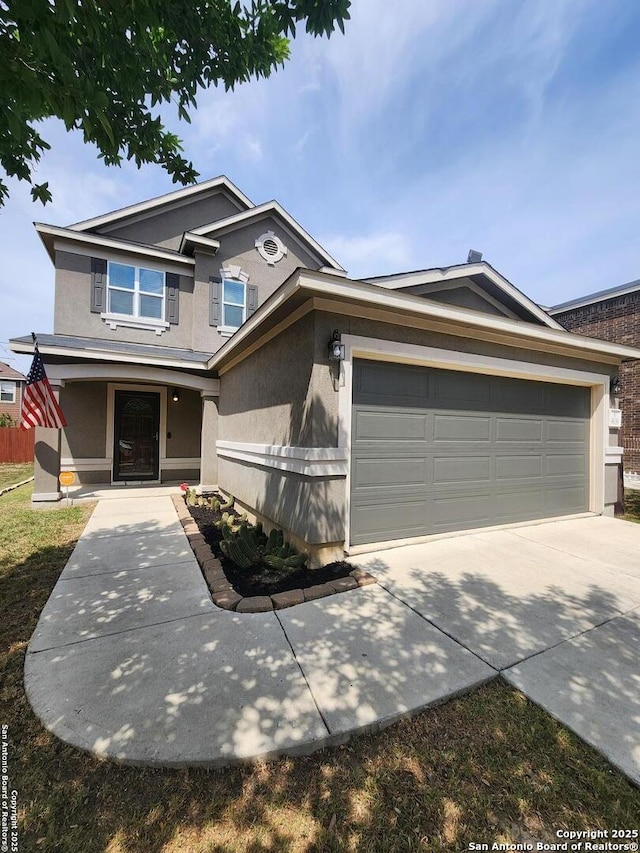 traditional home featuring stucco siding, an attached garage, and driveway
