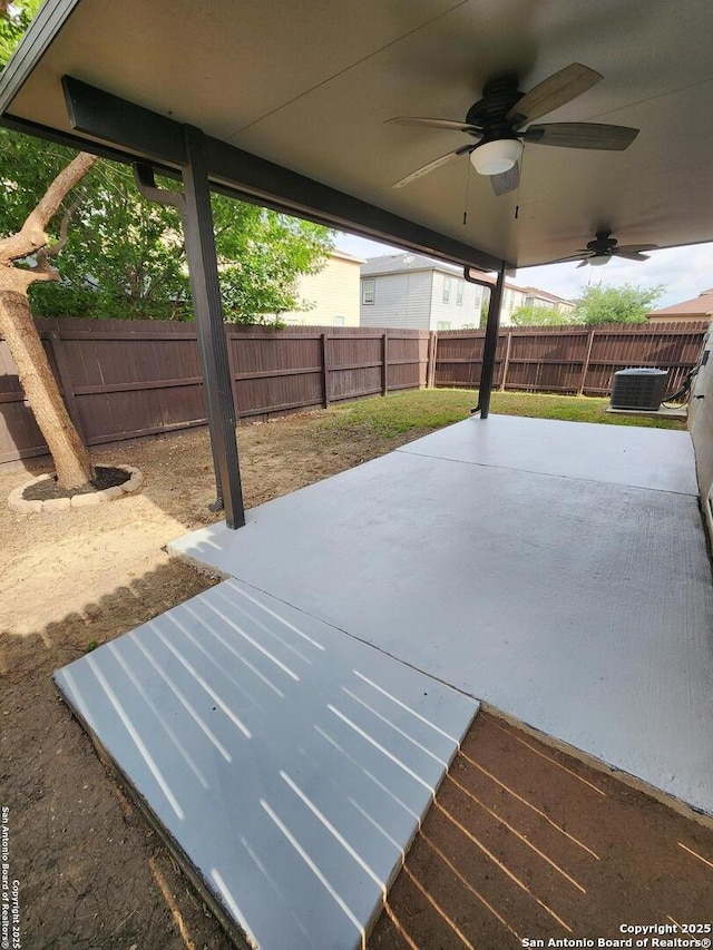 view of patio / terrace with central AC unit, a fenced backyard, and ceiling fan