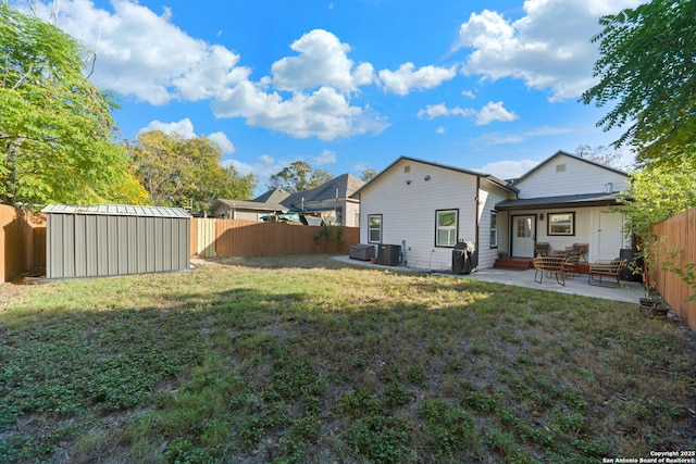 rear view of house featuring a storage unit, central air condition unit, a patio, and a fenced backyard