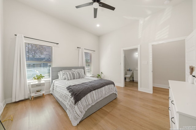 bedroom featuring baseboards, light wood-style floors, and multiple windows