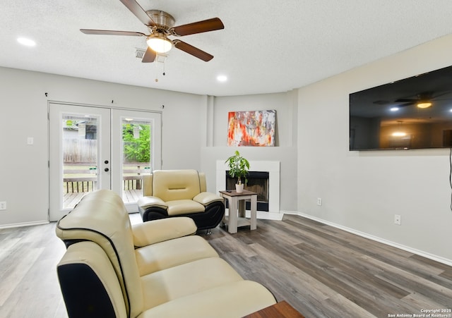 living room featuring recessed lighting, wood finished floors, ceiling fan, and french doors
