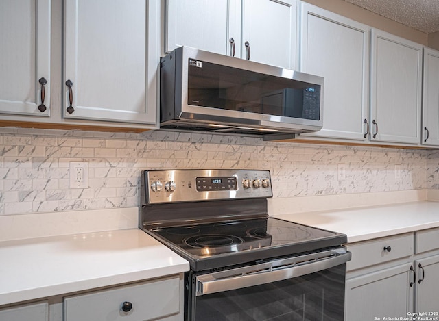 kitchen featuring backsplash, stainless steel appliances, and light countertops