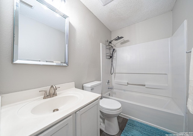 full bathroom with wood finished floors, toilet, vanity, tub / shower combination, and a textured ceiling