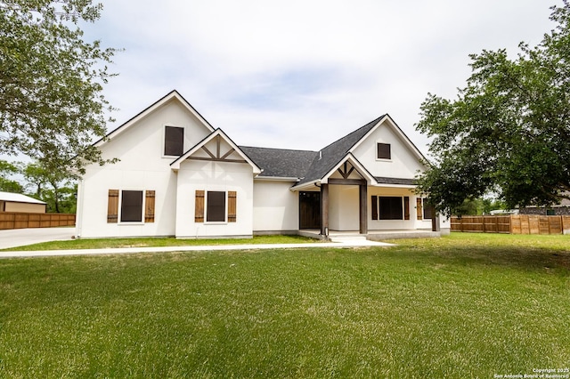 177 E Short Meadow Dr, Lytle, TX 78052 - modern inspired farmhouse with stucco siding, a front lawn, and fence