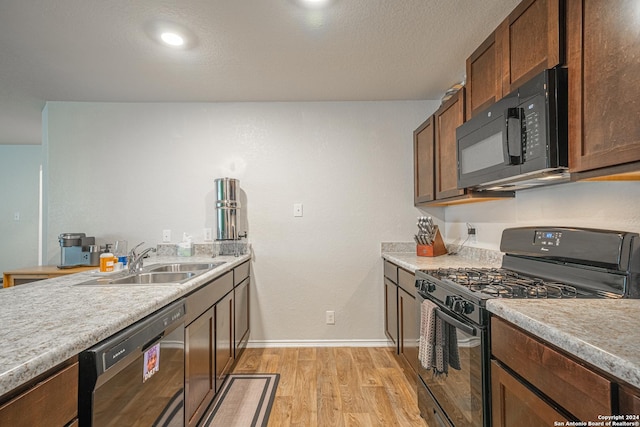 13907 Cyprus Sedge, San Antonio, TX 78254 - kitchen with a sink, black appliances, light wood-type flooring, light countertops, and baseboards