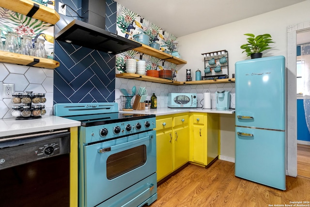 kitchen featuring black dishwasher, light countertops, open shelves, freestanding refrigerator, and stainless steel electric stove