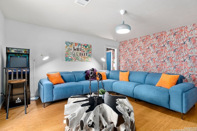 living room featuring light wood-style floors and visible vents