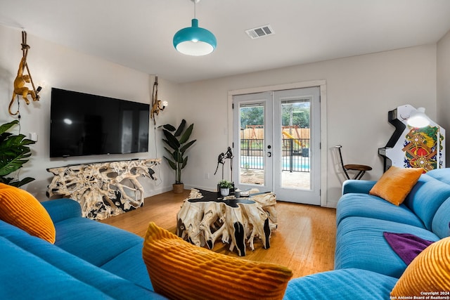 living room with french doors, wood finished floors, and visible vents