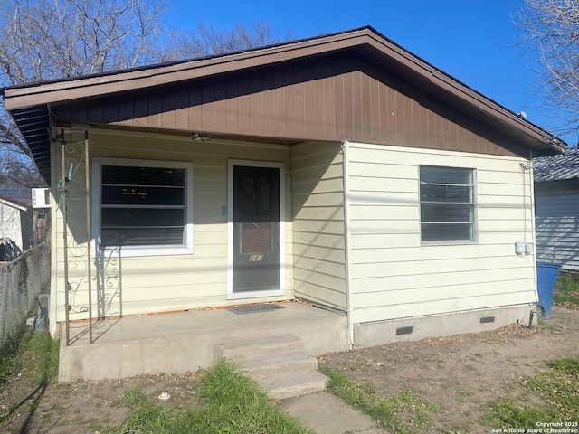 bungalow featuring crawl space, fence, and a porch