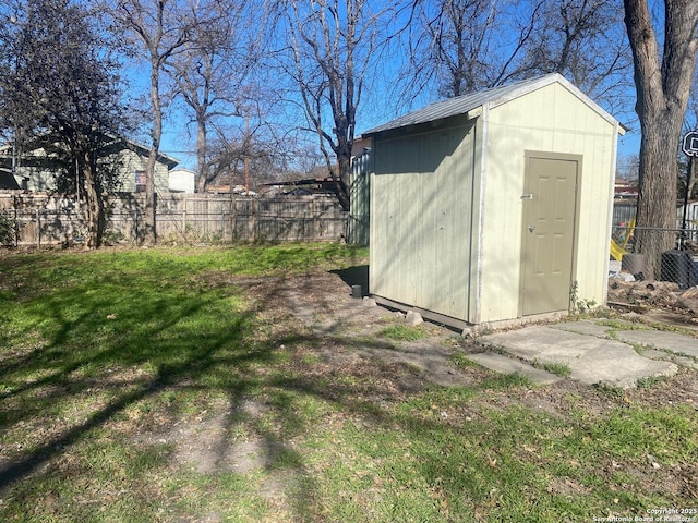 view of shed with cooling unit and a fenced backyard