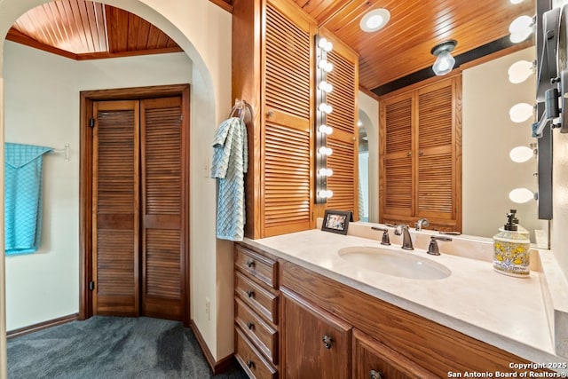 2802 State Highway 46, New Braunfels, TX 78132 - bathroom featuring a closet, wood ceiling, baseboards, and vanity