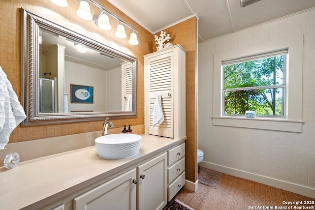 2802 State Highway 46, New Braunfels, TX 78132 - bathroom featuring vanity, toilet, ornamental molding, baseboards, and a shower