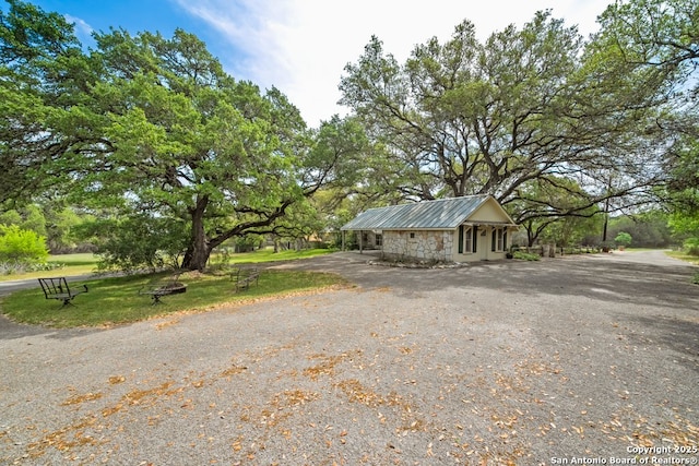 2802 State Highway 46, New Braunfels, TX 78132 - view of front of house with stone siding, metal roof, and a front yard