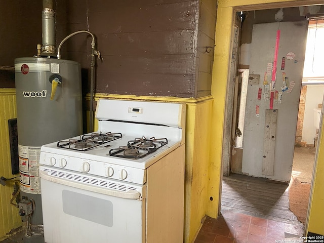 kitchen featuring water heater and white range with gas cooktop