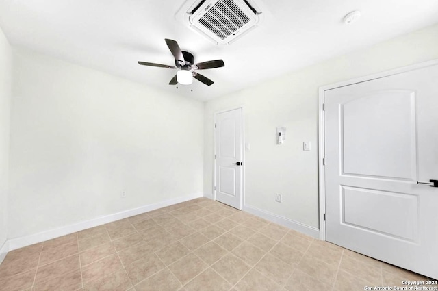 unfurnished room featuring baseboards, visible vents, and ceiling fan
